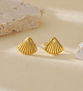 Close-up of golden fan-shaped shell stud earrings made of S925 sterling silver