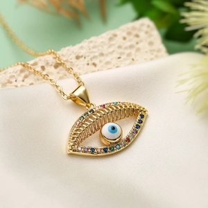 Gold 18K plated evil eye necklace with colorful zircon on beige textured fabric