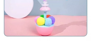 Detail of colorful plush balls on a pink tumbler base for interactive cat play toy