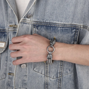 Macro detail of men's stainless steel wolf head bracelet with vintage finish