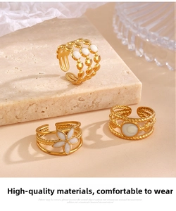 Detailed view of adjustable gold-plated stainless steel rings with white enamel flowers