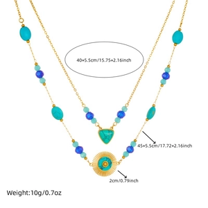 Double-layered gold chain necklace with turquoise beads and sunburst pendant, top view