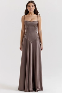 Detailed close-up showing the mocha satin dress texture and geometric seam stitching