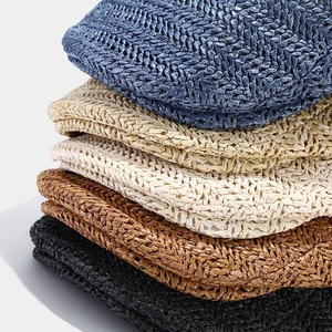 Stack of breathable woven straw berets in multiple colors with fine texture
