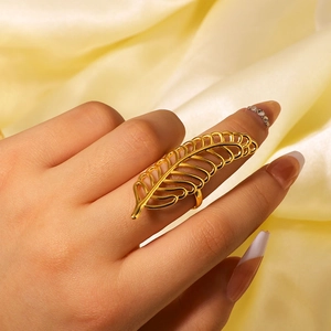 Gold leaf hollow ring in vintage stainless steel style worn on model with satin background