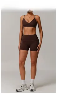 Detailed view of women's burnt brown V-neck sports bra and high-waist fitness shorts