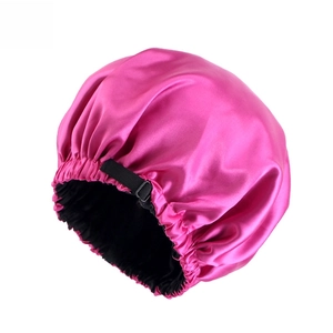 Detail of satin hair bonnet featuring adjustable black buckle and rose red silk texture