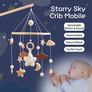 Handcrafted wooden baby crib mobile with hanging stars, moon, and clouds for nursery decor