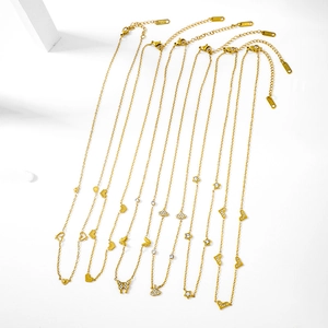 Detail view of eight gold butterfly and heart pendant necklaces with lobster clasps