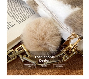 Close-up of fluffy cow pattern tote bag with gold chain and plush ball ornament