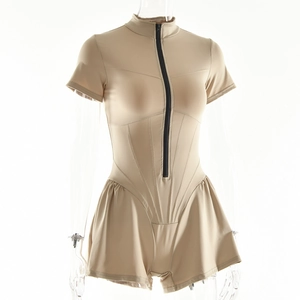 Close-up of beige short sleeve bodysuit featuring a front black zipper and pleated hem