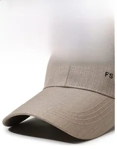 Detail of khaki baseball cap featuring premium FS FASHION embroidery and twill texture