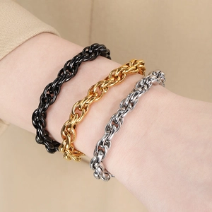 Detailed close-up of three thick Cuban link bracelets in gold, black, and silver steel