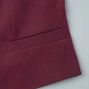 Detailed view of the flap pocket and twill fabric on a wine red vest suit set