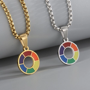 Macro detail of rainbow enamel wheel pendants on gold and silver stainless steel box chains