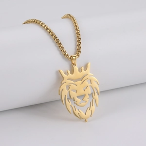 Detail of a golden crown lion head pendant with a box chain on white display