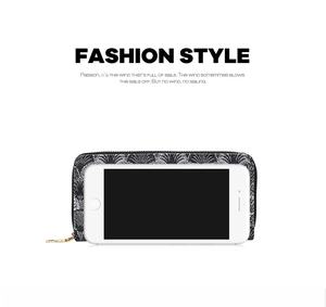 Detail view of a long lace-pattern wallet showing large capacity for smartphones