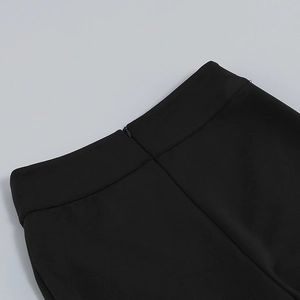 Detail of high waist black trousers featuring a seamless hidden back zipper and woven fabric