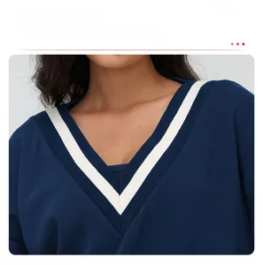 Macro view of V-neckline with striped knit detail on navy blue sporty sweatshirt