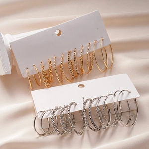 12-piece geometric gold and silver hoop earrings set with rhinestones on satin