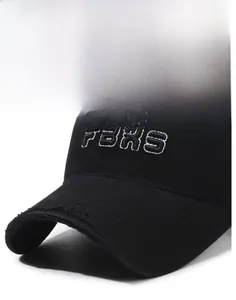 Detail of FBXS embroidery and distressed torn brim on a black vintage baseball cap
