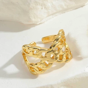 Detailed macro view of golden double-layered chain hollow ring on white stone base