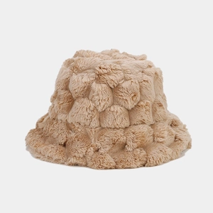 Detailed close-up of beige faux rabbit fur bucket hat with warm pineapple texture