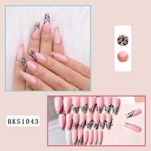 Detail view of long coffin nails with pink ombre butterfly and gold glitter French tips