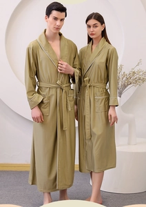 Detail of olive green waffle robe with white piping and textured fabric for couples