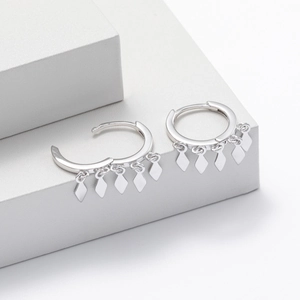 Detailed shot of S925 sterling silver hoop earrings with five dangling diamond-shaped charms