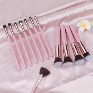 Detailed view of 12pcs pink makeup brushes with rose gold ferrules on satin silk