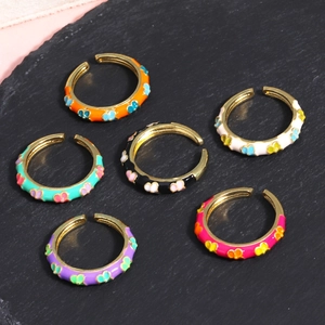 Detailed macro view of colorful enamel butterfly open rings in various vibrant shades