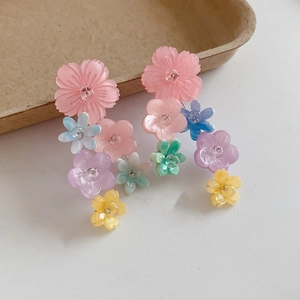 Detail of colorful resin flower drop earrings with a vibrant pastel gradient finish