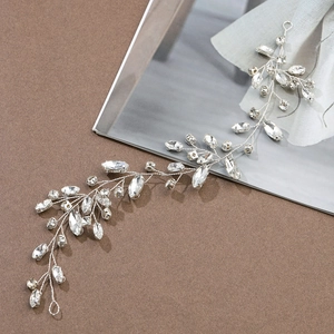Detailed close-up of handmade bridal hair vine with silver wire and clear rhinestones