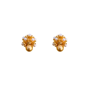 Golden flower-shaped pearl earrings with a vintage luxury design on white background