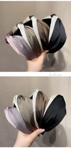 Detail of elegant satin knotted headbands in various colors with a silky texture finish