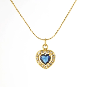 Elegant gold titanium steel heart necklace featuring a blue gemstone and crystal border