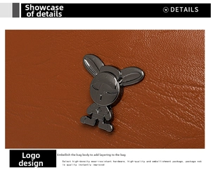 Close-up of caramel leather bag with metallic rabbit hardware and lychee grain texture