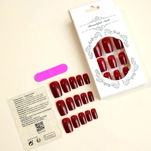 Macro view of burgundy long square press-on nails set with nail file and adhesive tabs