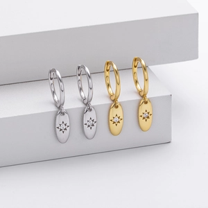 Detail of S925 silver starburst hoop earrings with gold and silver octagon charms
