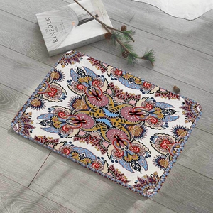 Detail of bohemian mandala flannel floor mat on wooden floor with rustic home decor