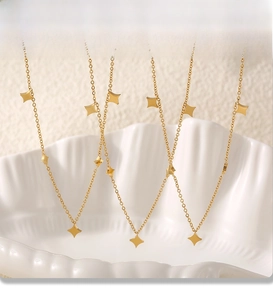 Detail of PVD plated gold stainless steel necklaces with tiny star shaped charms