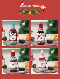 Detail view of four Christmas knitted wine bottle covers with snowman and Santa patterns