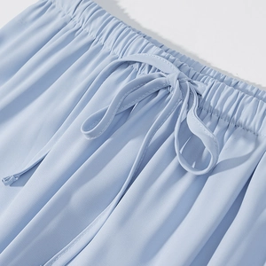 Detail showing elastic waistband with drawstring on light blue casual shorts
