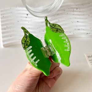 Green leaf shaped acetate hair claw clip for high ponytail styling and elegant updo