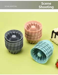 Three-color Savarin style silicone muffin molds stacked neatly on a light green background