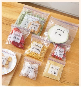 Thickened transparent freezer bags with label areas for organized food storage on wood
