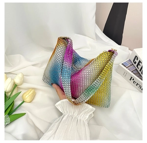 Detailed macro view of vibrant rainbow rhinestone gradients on a luxury hobo shoulder bag