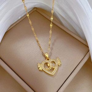 Elegant gold heart angel wing mama necklace displayed in a beige jewelry gift box