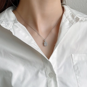 Elegant S925 sterling silver necklace with geometric zircon pendant shown on a model